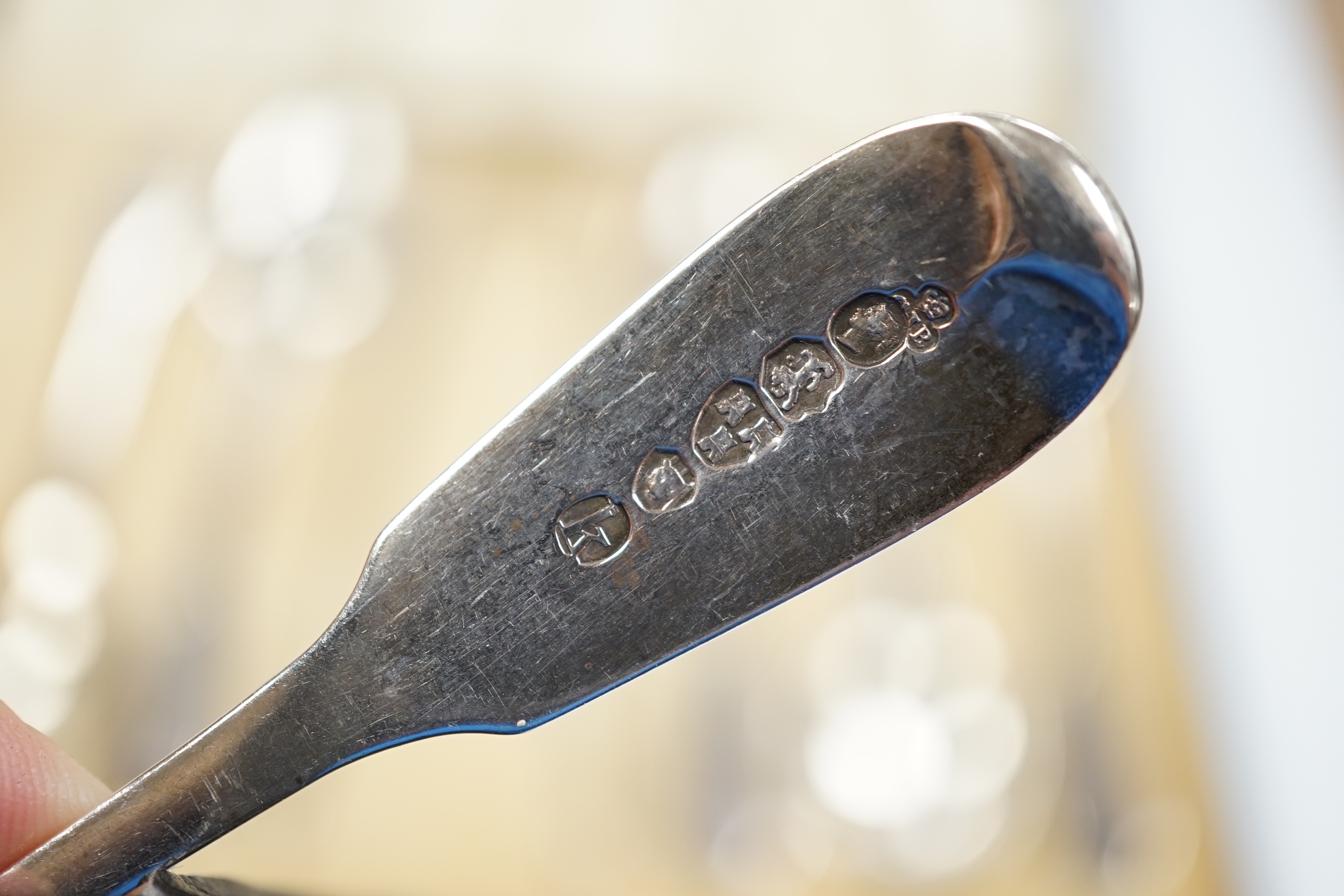A set of six Victorian provincial silver fiddle pattern teaspoons, Reid & Sons, Newcastle, 1873 and a pair of associated silver sugar tongs, in associated case.